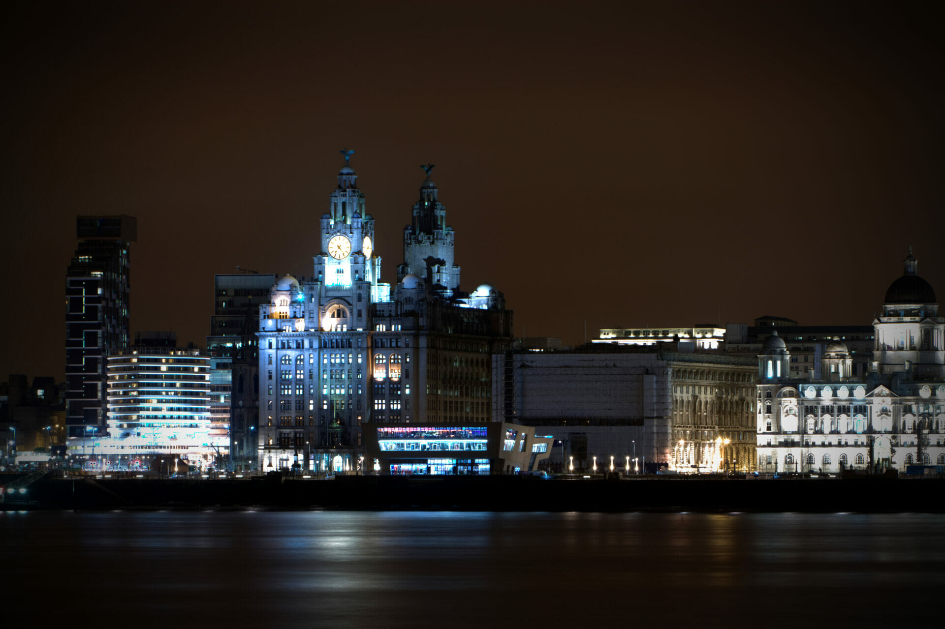 Photo taken at night of the Liverpool Skyline showing historic buildings shot from Birkenhead Liverpool Skyline & Low-Light Photography