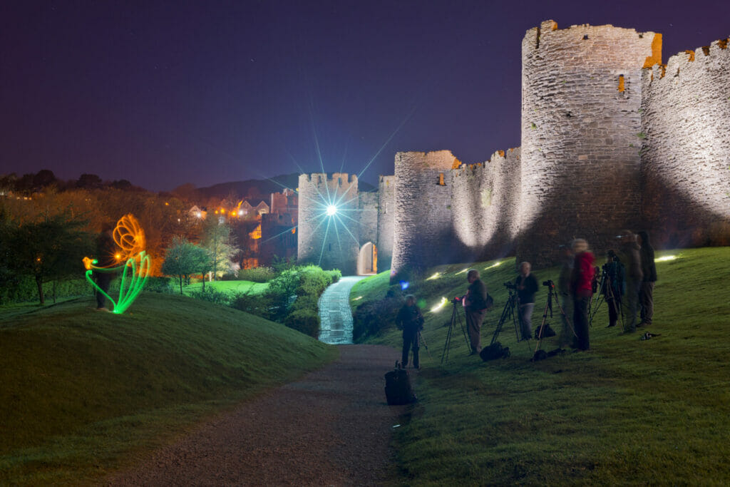 A behind the scenes photo taken at a Welshot Photographic low light, long exposure and painting with light academy evening