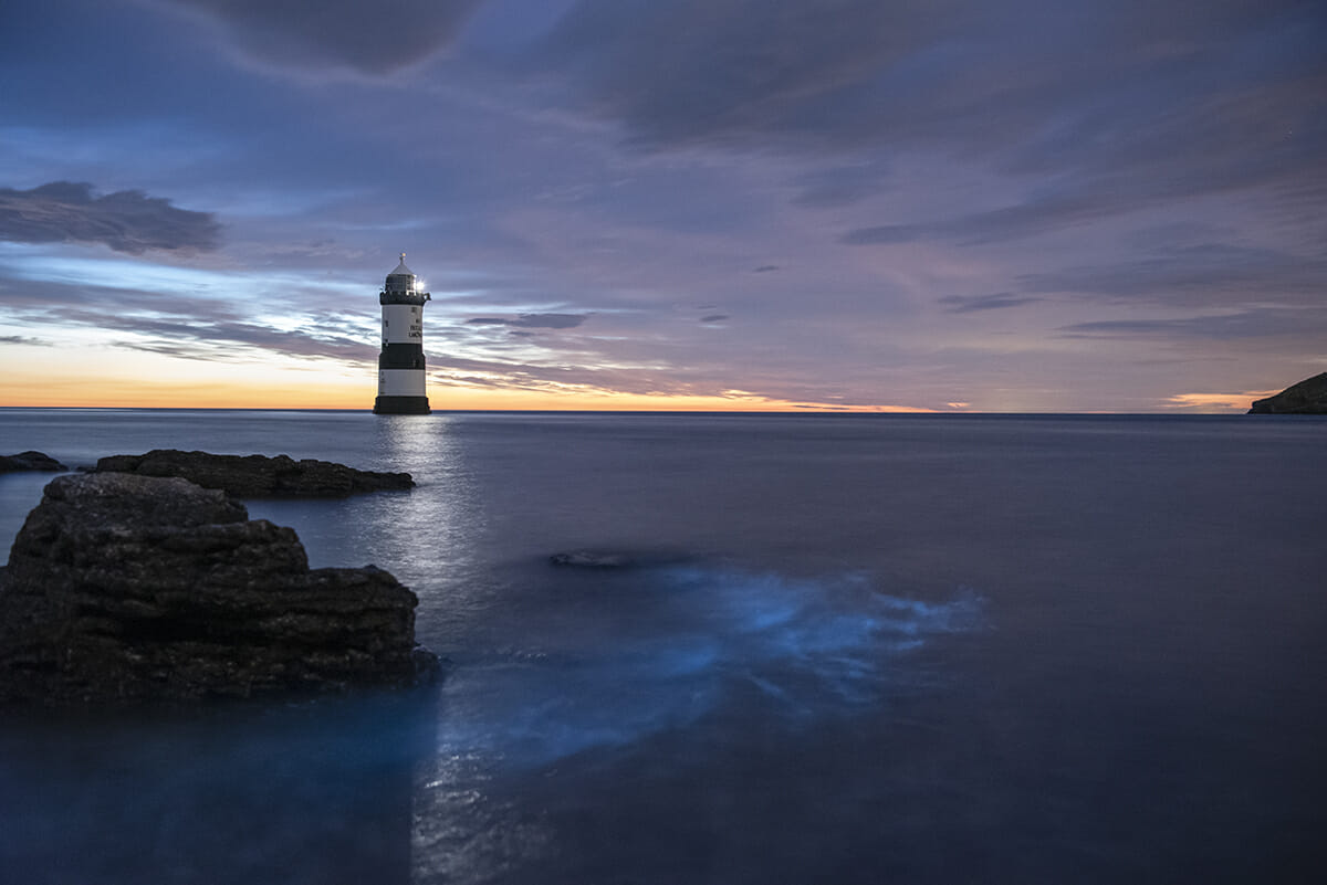 Colour Photo of Lighthouse at Penmon Point Anglesey with Bioluminescent in the sea - Taken on the Shortest Night Photographic Adventure with Welshot Imaging Photographic Academy