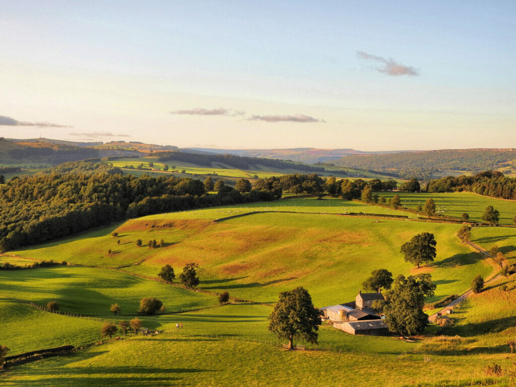 A Day In Buxton - Photography In The Peak District - Photo showing the rolling hills , trees and farm buildings in the Peak district