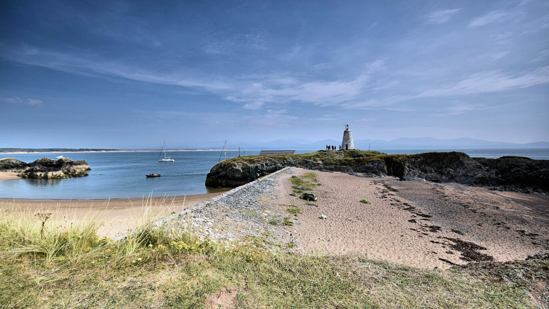 From Sunrise to Sunset on Anglesey - Landscape photo with a huge blue sky and overlooking the lighthouse on Llanddwyn Island on Anglesey