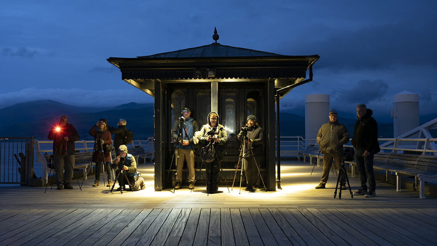 Photo of a group of photographers using tripods doing low-light photography at a Welshot Photographic Workshop