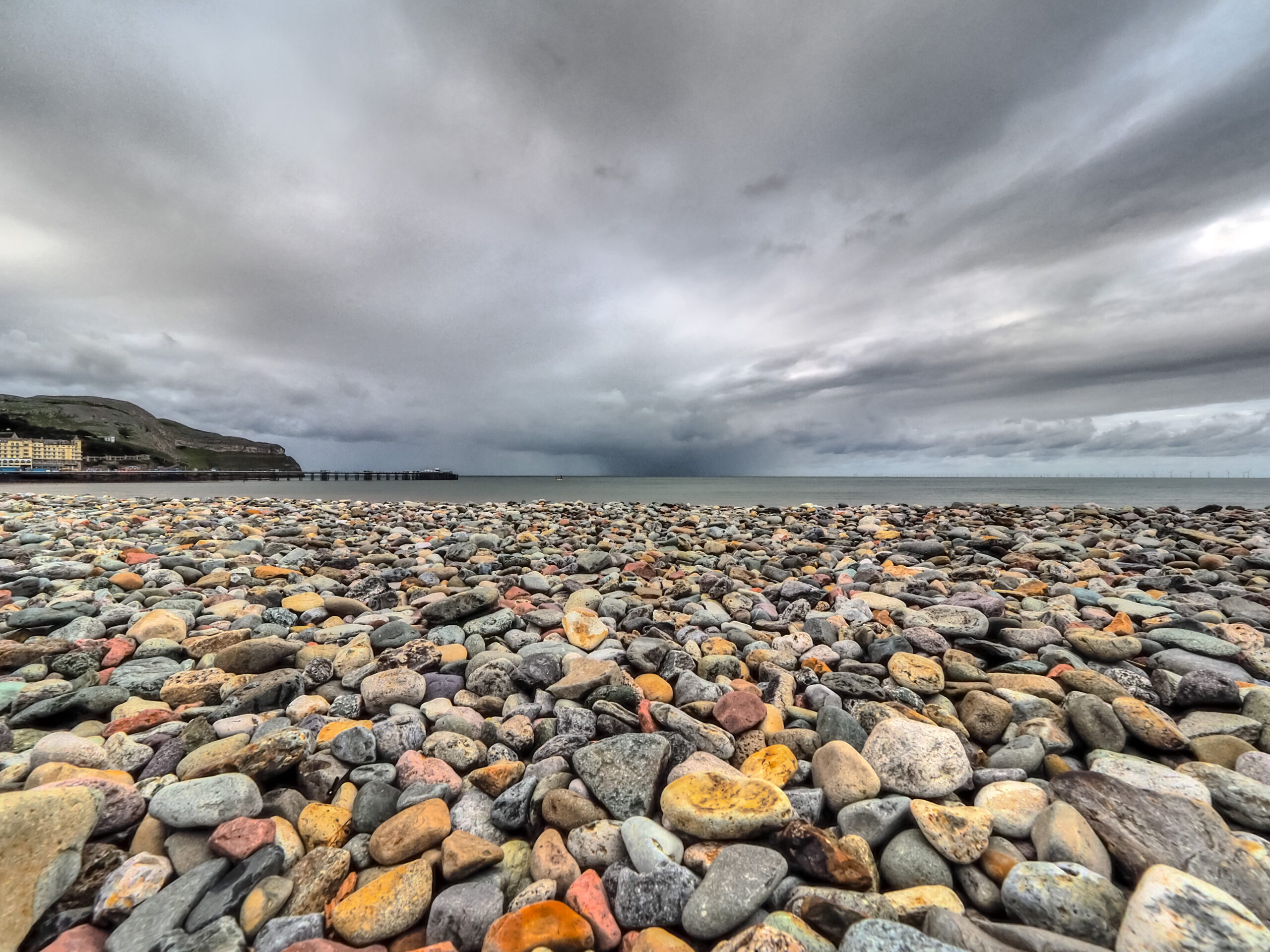 Low Viewpoint taken from the Llandudno Beach front looking towards the pier with dark and brooding sky